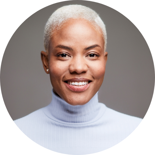head shot of a short blonde hair woman wearing a light blue turtle neck.